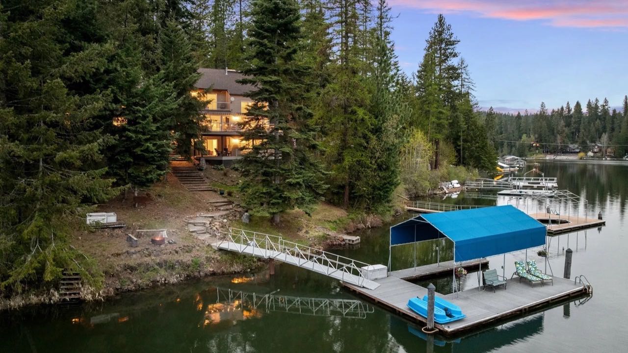 A dock at sunset on Lake Coeur d'Alene, where dock spiders build heavy webs over the water